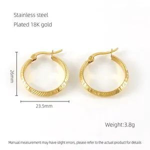 Detail of 18K gold plated stainless steel hoops with Greek meander pattern engraving
