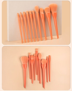 Detail of 12-piece orange makeup brush set with soft synthetic bristles and glossy handles