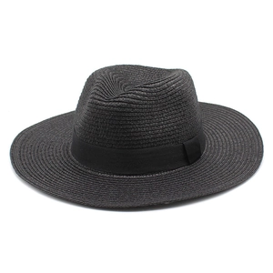 Detailed view of black woven straw panama hat with matching ribbon and fine texture