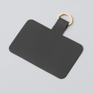 Close-up of matte black TPU phone lanyard patch with a secure gold metal D-ring buckle