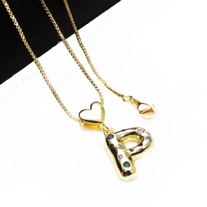 Detail of gold box chain necklace featuring letter P pendant with colorful zircon stones