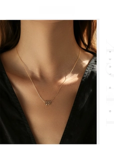 Detail of gold S925 silver necklace with 333 lucky angel number pendant on model