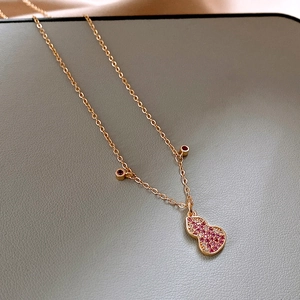 Macro detail of rose gold gourd pendant necklace with pink and white zircon stones