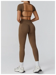 Detail of hollow-out back yoga top and high-waist scrunch leggings in brown color