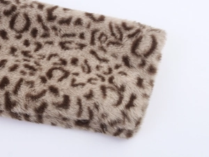 Close-up detail of plush faux fur texture with classic leopard print pattern