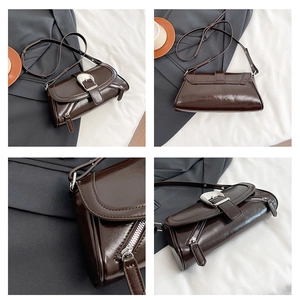 Detail view of dark brown leather shoulder bag with silver buckle and refined hardware