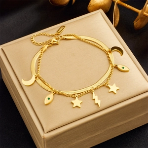 Detailed close-up of double-layered gold stainless steel bracelet with celestial charms