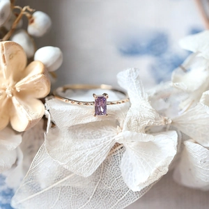 Detailed close-up of a vintage purple amethyst ring with rectangle-cut gemstone and gold band