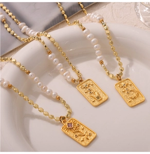 Detailed view of vintage relief pendants with freshwater pearls and star-moon motifs