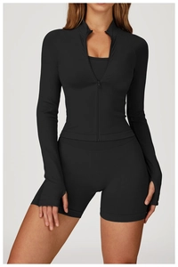 Detail of slim fit black yoga jacket with thumbholes and high waist sports shorts