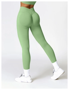 Close-up of high-waisted seamless green yoga leggings with V-shaped waistband and scrunch butt