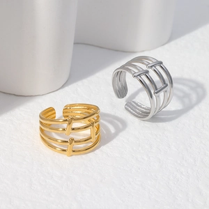Detail of minimalist geometric hollow layered rings in gold and silver stainless steel