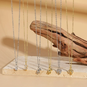 Detail of bear and elephant pendants with sparkling cubic zirconia on gold and silver chains