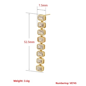 Detail view of 18K gold plated long earrings featuring 8 rectangular cubic zirconia stones