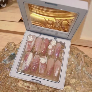 Pink cat-eye press-on nails with 3D white roses and pearls in a premium display box