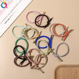Detailed view of colorful ribbed knotted hair ties with stylish gold metal fasteners