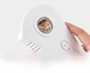 Close-up of white multifunctional bottle opener prying a beer cap with metal tip