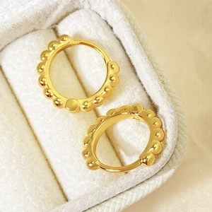 Minimalist golden beaded hoop earrings with vintage wave texture in a jewelry box