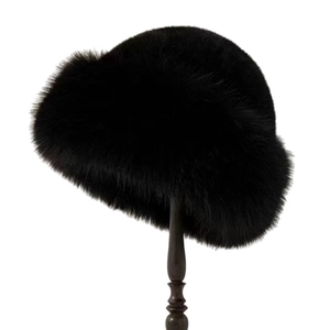 Winter plush black faux fur bucket hat with thick warm material on a display stand