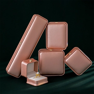Rose gold PU leather jewelry storage boxes set for rings and necklaces on green velvet