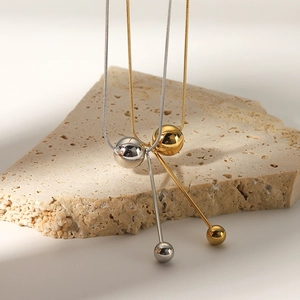 18k gold and silver plated stainless steel necklaces with spherical pendants on stone