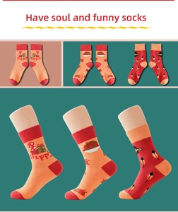 Detail of mid-calf socks featuring orange festive turkey and happy gift box patterns