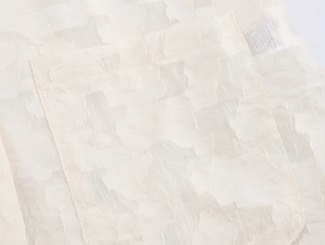 Gros plan sur la dentelle blanche et les détails de la poche d'un blazer pour femme