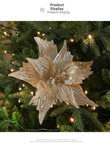 Macro detail of artificial golden Christmas poinsettia with glitter on a festive tree