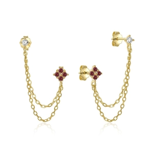 Close-up of S925 silver gold earrings with red gems and engraved hallmark detail