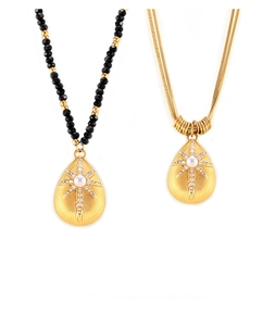 French style gold teardrop starburst pendant with pearl and black beaded chain details