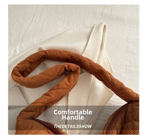 Detail of retro brown quilted corduroy tote bag showing thick handles and zipper closure