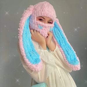 Detail of pink and blue chunky knit bunny ear balaclava showing soft chenille texture