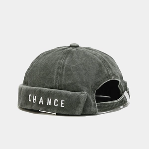 Detail view of cotton docker cap with white CHANCE embroidery and washed texture