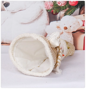 Detail view of the open bottom on white and gold knitted Santa bottle cover