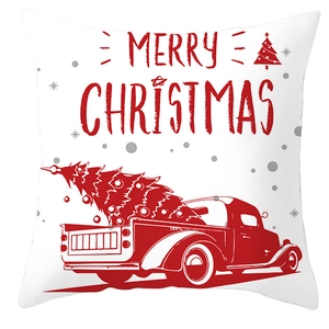 Close-up of white fabric pillowcase with red Merry Christmas text and reindeer motifs