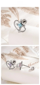 Detail of star-themed stud earrings featuring blue, purple, and pink square gemstones