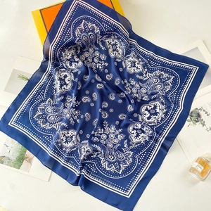 Dark blue paisley silk scarf with vintage patterns displayed with elegant gift box