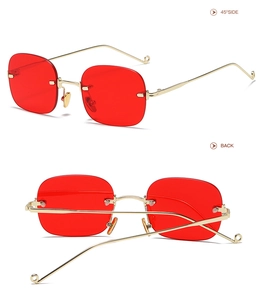 Detail view showing the 45-degree side and back of red rimless square sunglasses