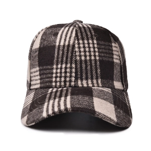 Detailed view of the thick wool plaid baseball cap with black and grey textured fabric
