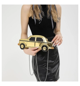 Detail of creative gold mirror car clutch with retro taxi checkered pattern and chain