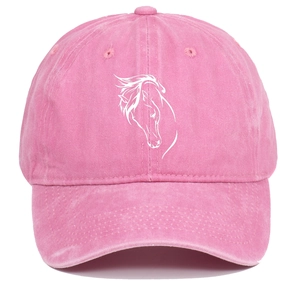 Detail view of pink washed cotton fabric texture and white horse head embroidery on cap