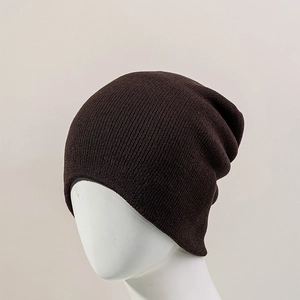 Detail of dark brown knitted beanie showing fine texture and elastic ribbing material