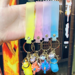 Detailed view of silicone wristband keychains with colorful charms and golden hooks
