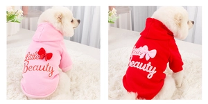 Detail of pink and red dog hoodies with Little Beauty print and 3D bow decoration