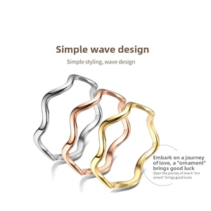 Macro detail of three minimalist wave rings in silver, gold, and rose gold finish