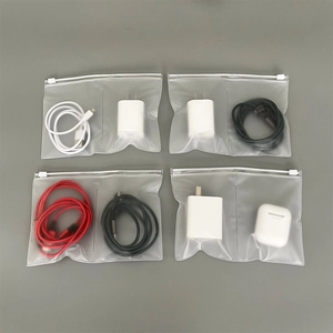 Set of four frosted PVC zipper bags organizing electronic cables and chargers on grey background