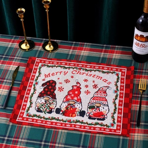 Detail of Christmas table mat featuring Nordic gnomes and Merry Christmas script