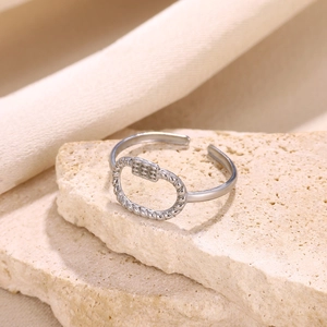 Detailed macro view of an oval silver ring with a rope edge and mesh pattern on stone