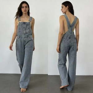 Front and back view of loose denim overalls in vintage wash blue with X-shaped straps