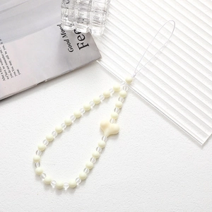 Detail of acrylic beaded phone strap featuring a large frosted heart pendant and milky beads